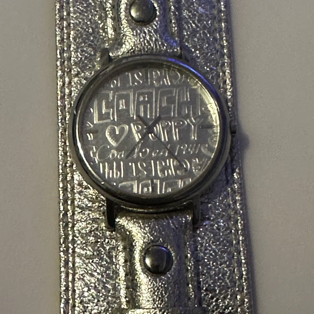 Coach Poppy cuff watch. Genuine leather with silver metallic‎ design. Vintage